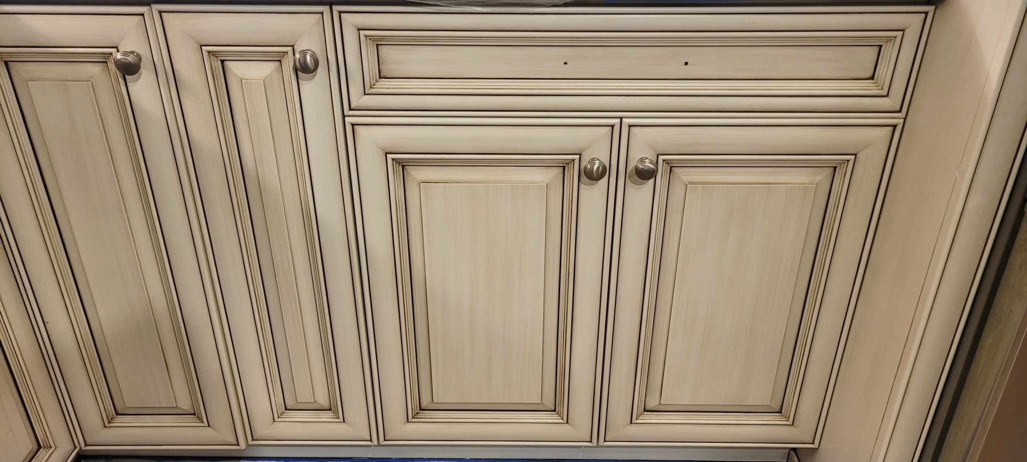 Kitchen cabinet doors and drawer front after refinishing with antiquing glaze.
