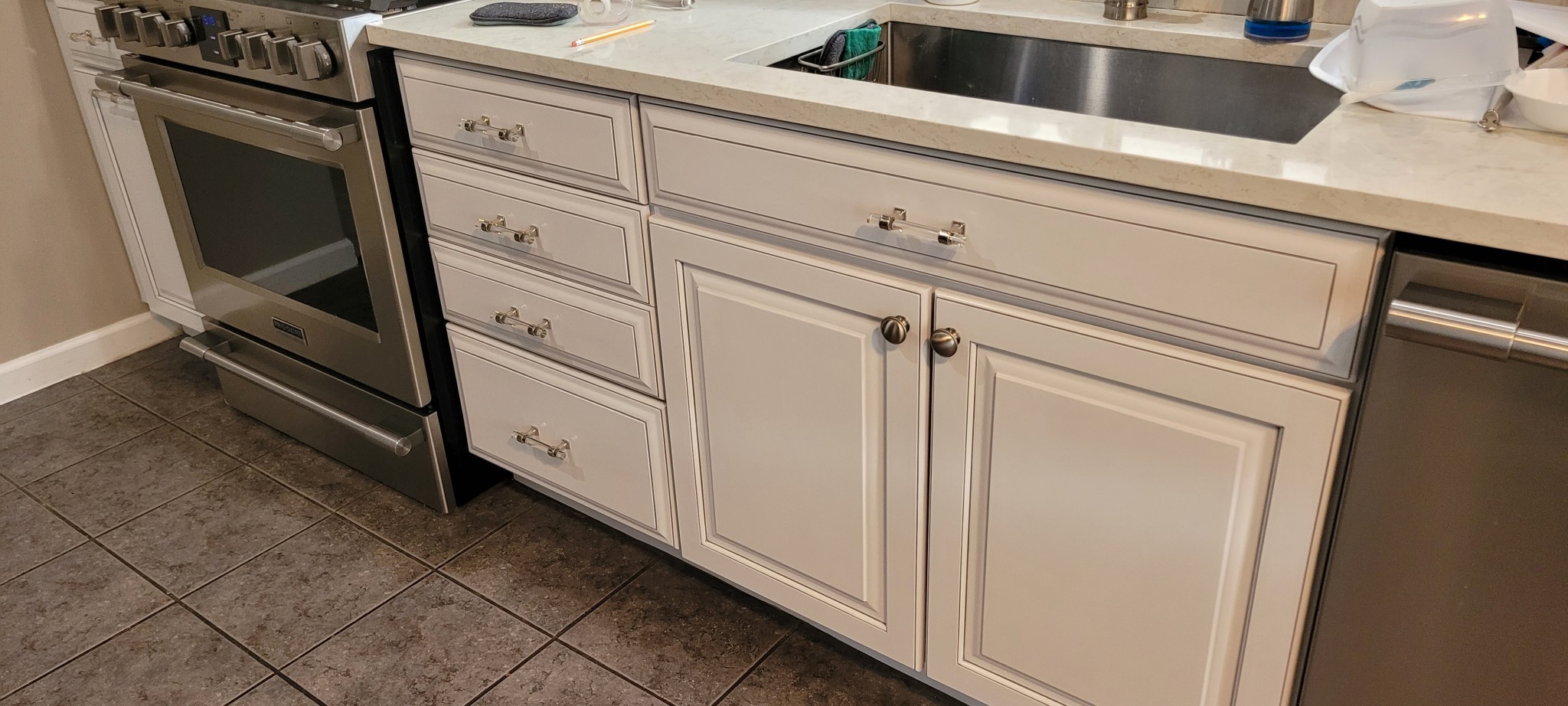 Off-white kitchen cabinet doors and drawers after professional refinishing.