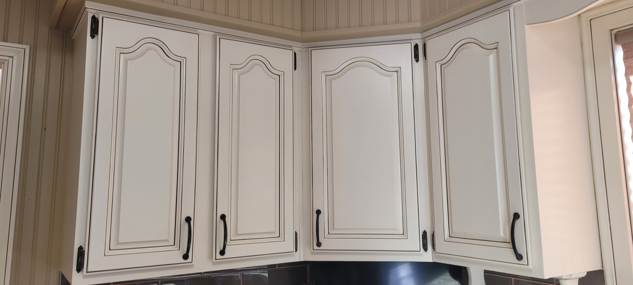 Off-white kitchen cabinet doors with dark glaze and distressed finish