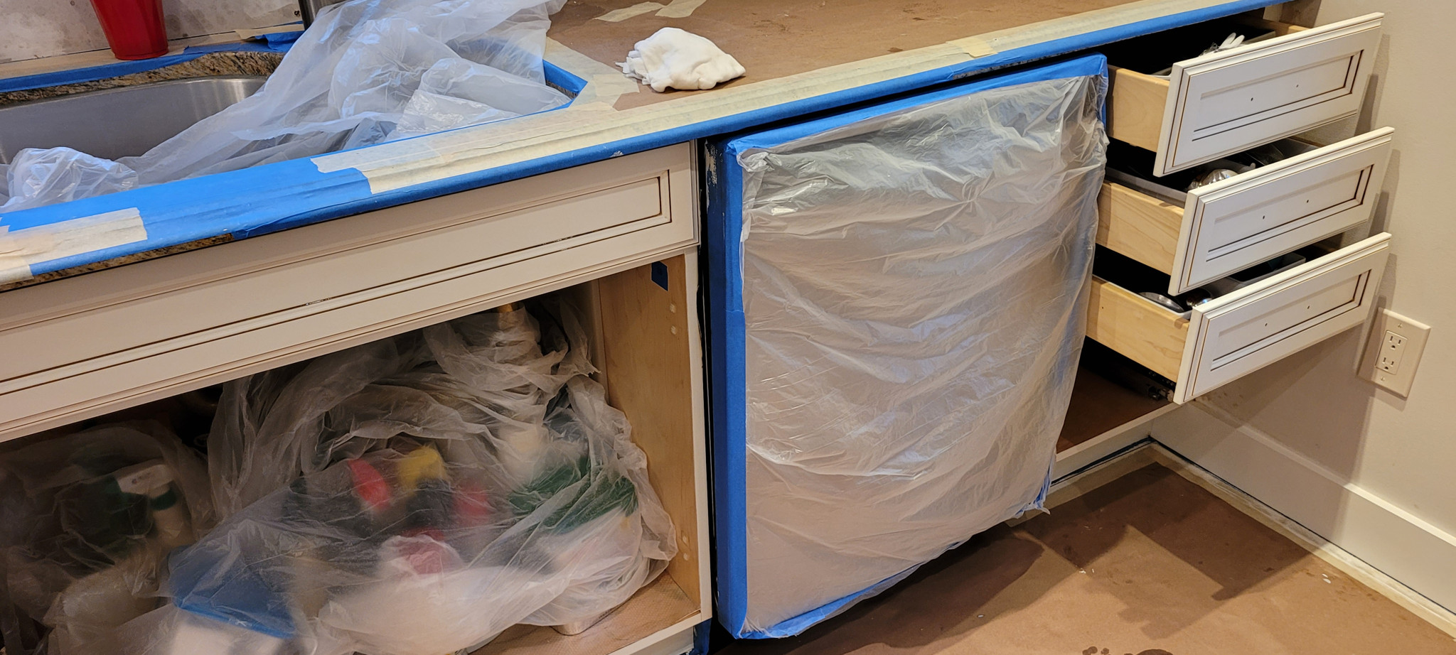 Cabinets masked and protected before work