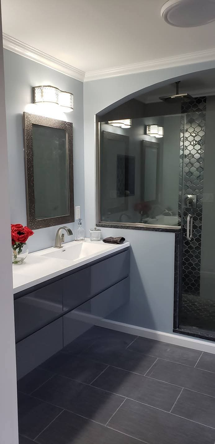Bathroom walls painted light gray, with white ceiling, crown molding, and baseboards.