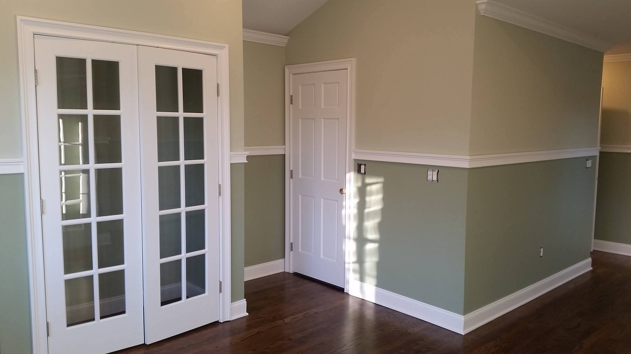 Freshly painted interior walls with two-tone finish and white trim.