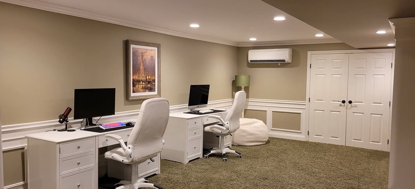 Interior room with beige walls, white trim, crown molding, and painted paneled doors.
