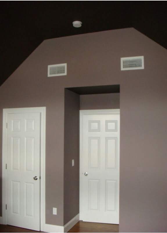 Interior room with dark gray ceiling, light brown walls, and white doors and trim.