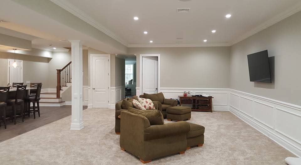 Interior walls painted light gray, with white wainscoting and trim, and crown molding.