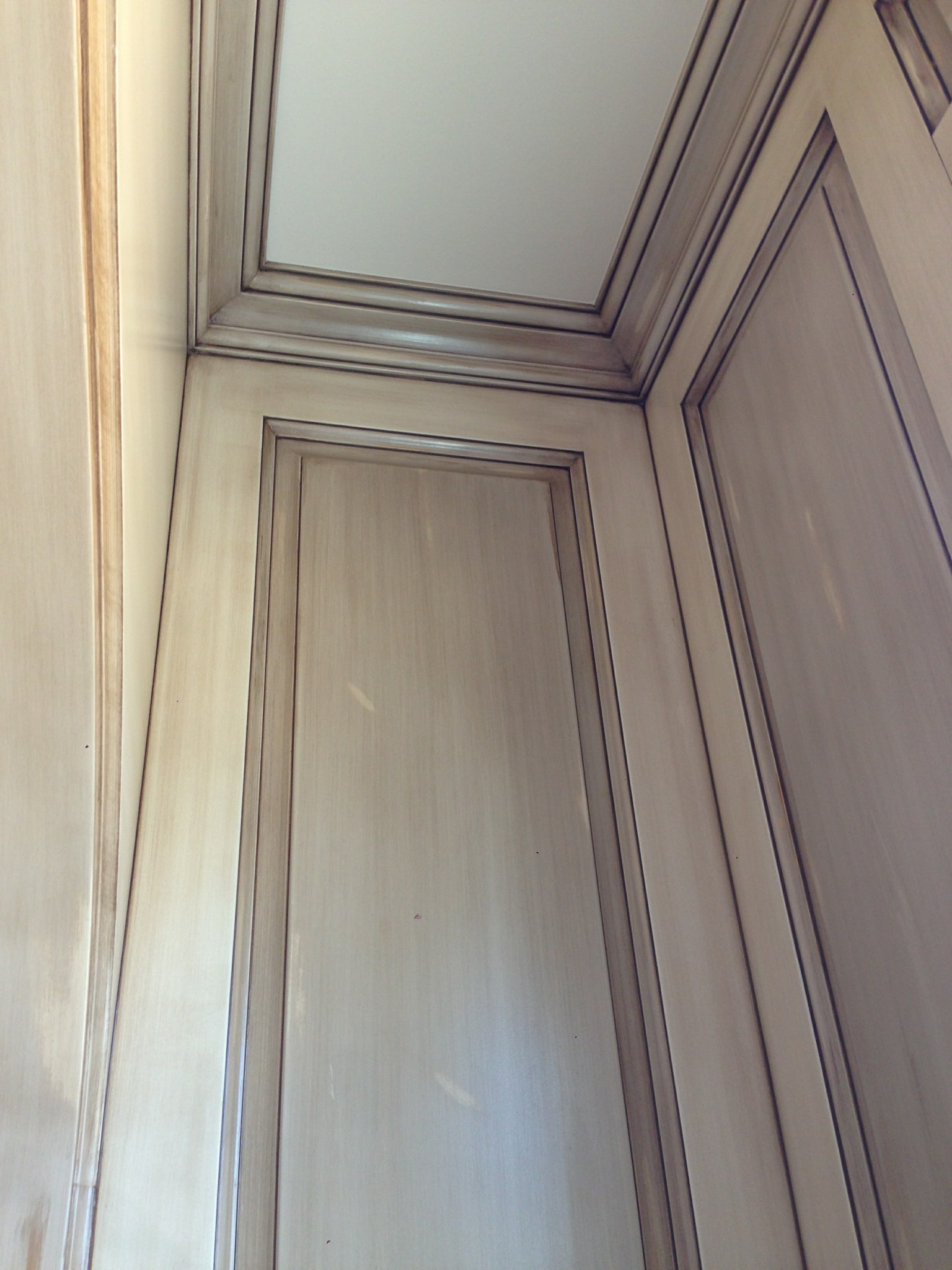 Kitchen cabinet doors and crown molding with antiquing finish.