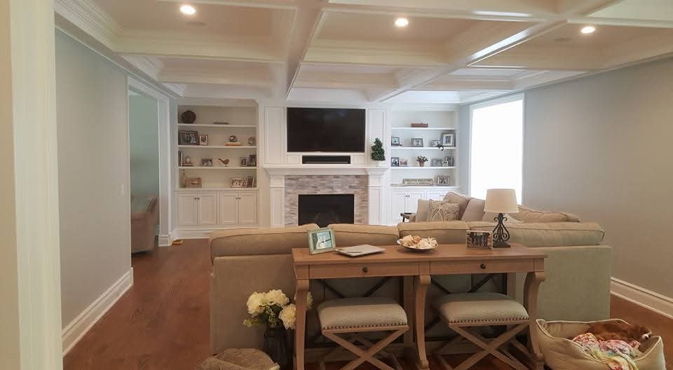 Living room with painted walls, white trim, and coffered ceiling.