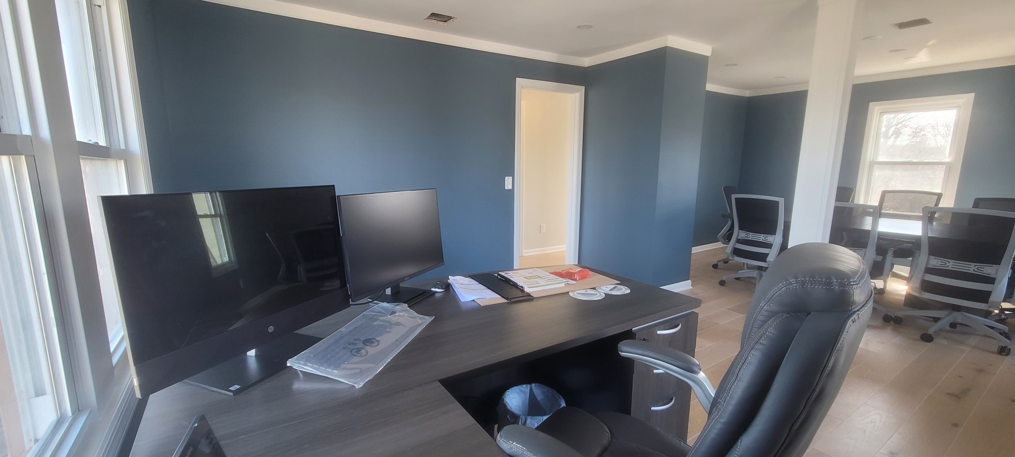 Navy blue walls with white crown molding and window trim in an interior space.