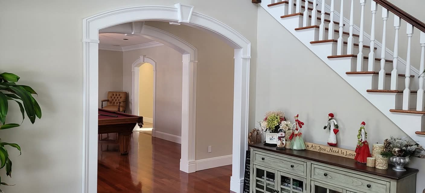 Repainted interior walls and white archway trim, staircase risers, and balusters.