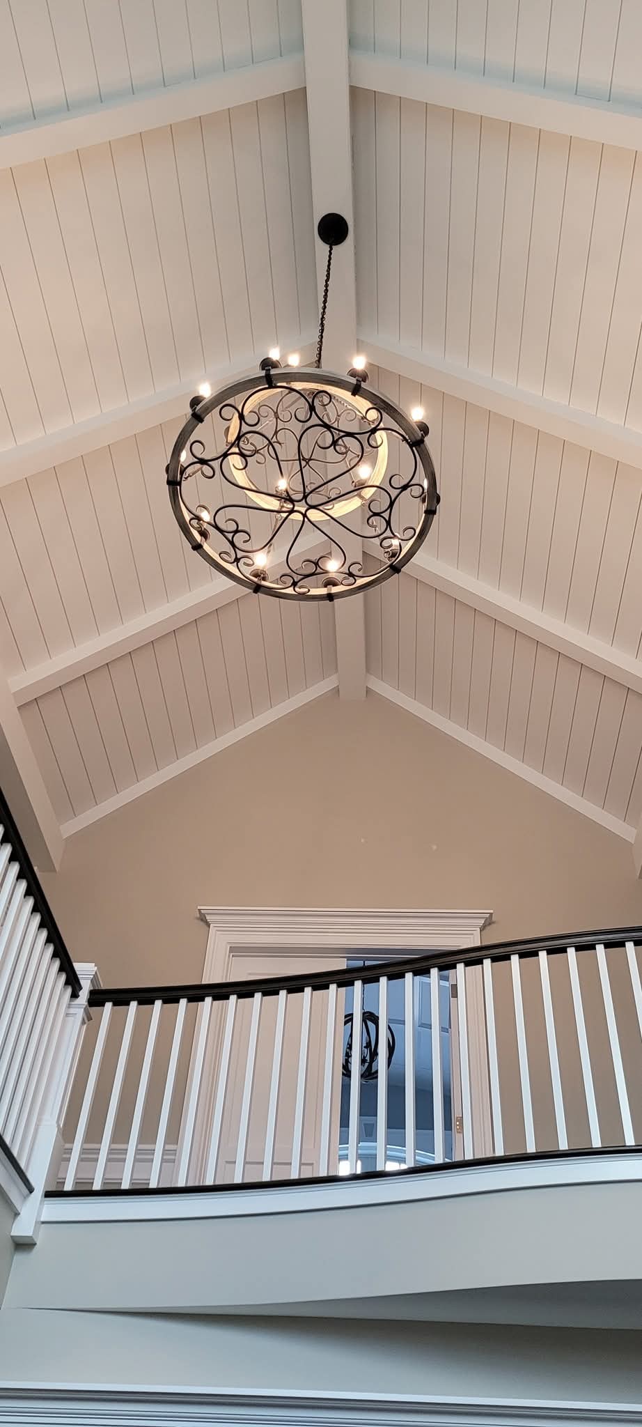 Vaulted ceiling with shiplap boards and exposed beams painted off-white.