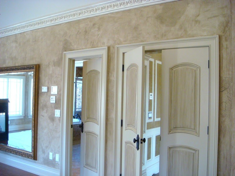 Walls with faux finish, white crown molding, painted interior doors, and door frames.
