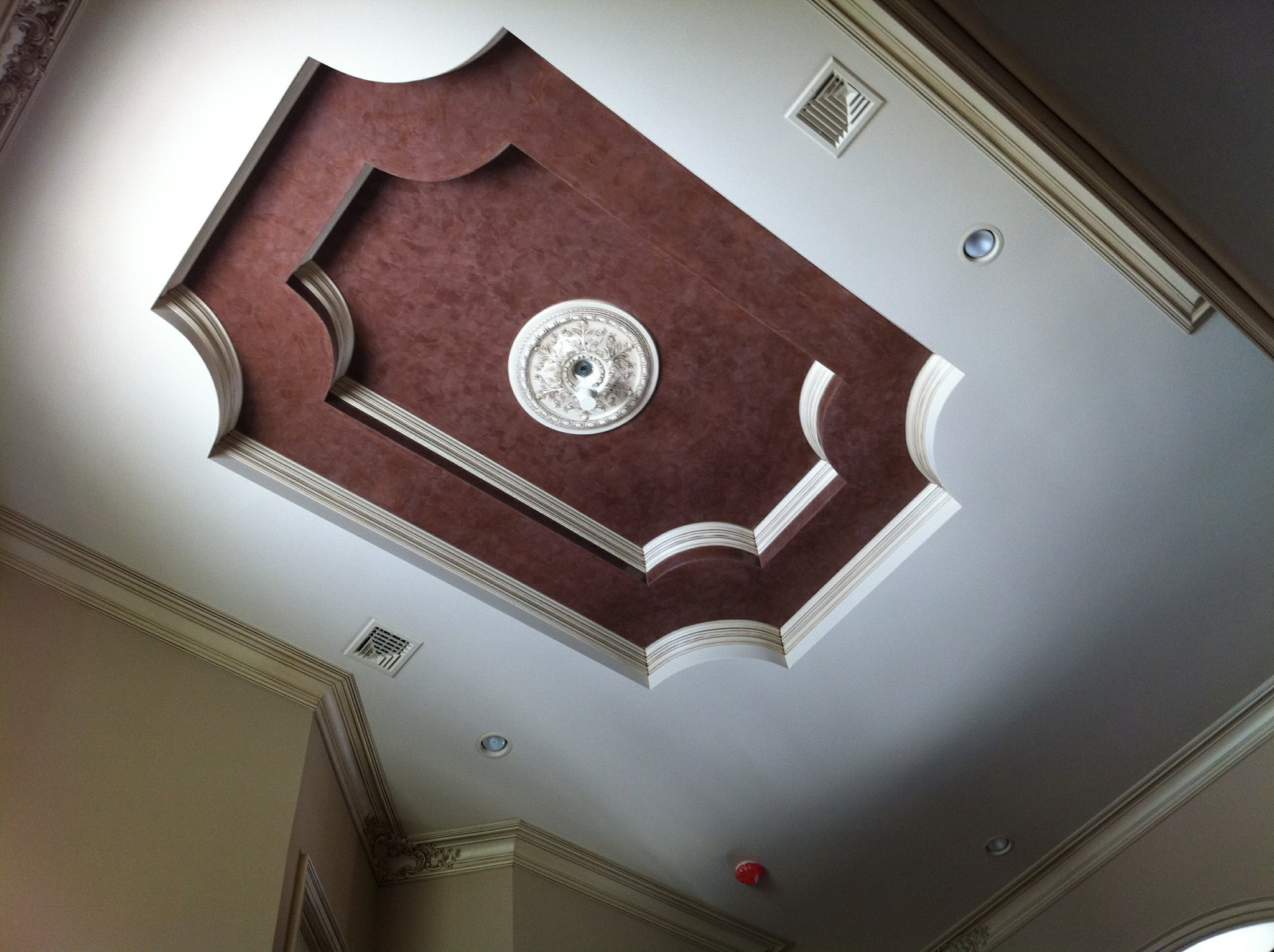 Ceiling medallion and soffit painted with faux finish, contrasting light trim and ceiling.