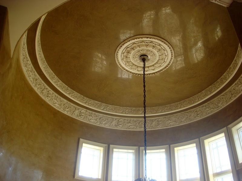 Curved interior walls and domed ceiling with decorative molding and glaze finish.