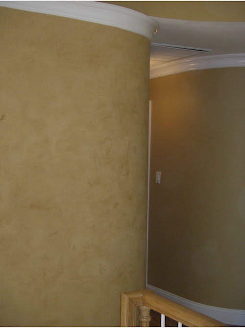 Curved interior walls with a faux finish and white painted crown molding.
