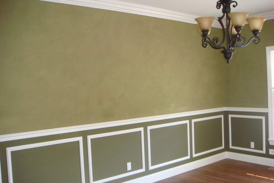 Interior room walls with decorative finish above wainscoting and white crown molding.