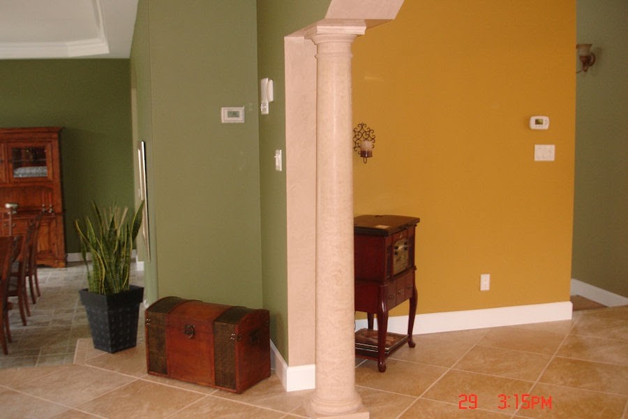 Interior walls painted in contrasting colors with white baseboards and crown molding.