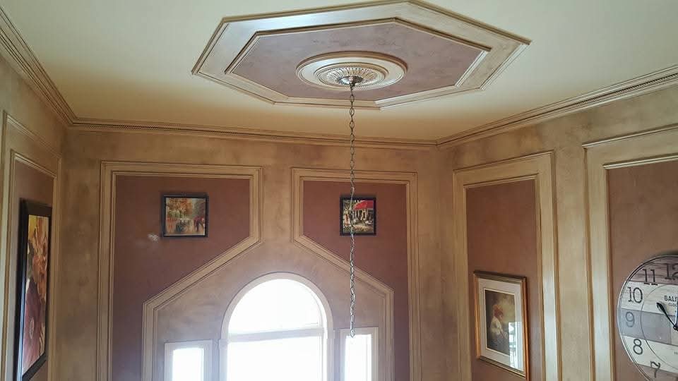 Interior walls with faux finished trim and ceiling medallion