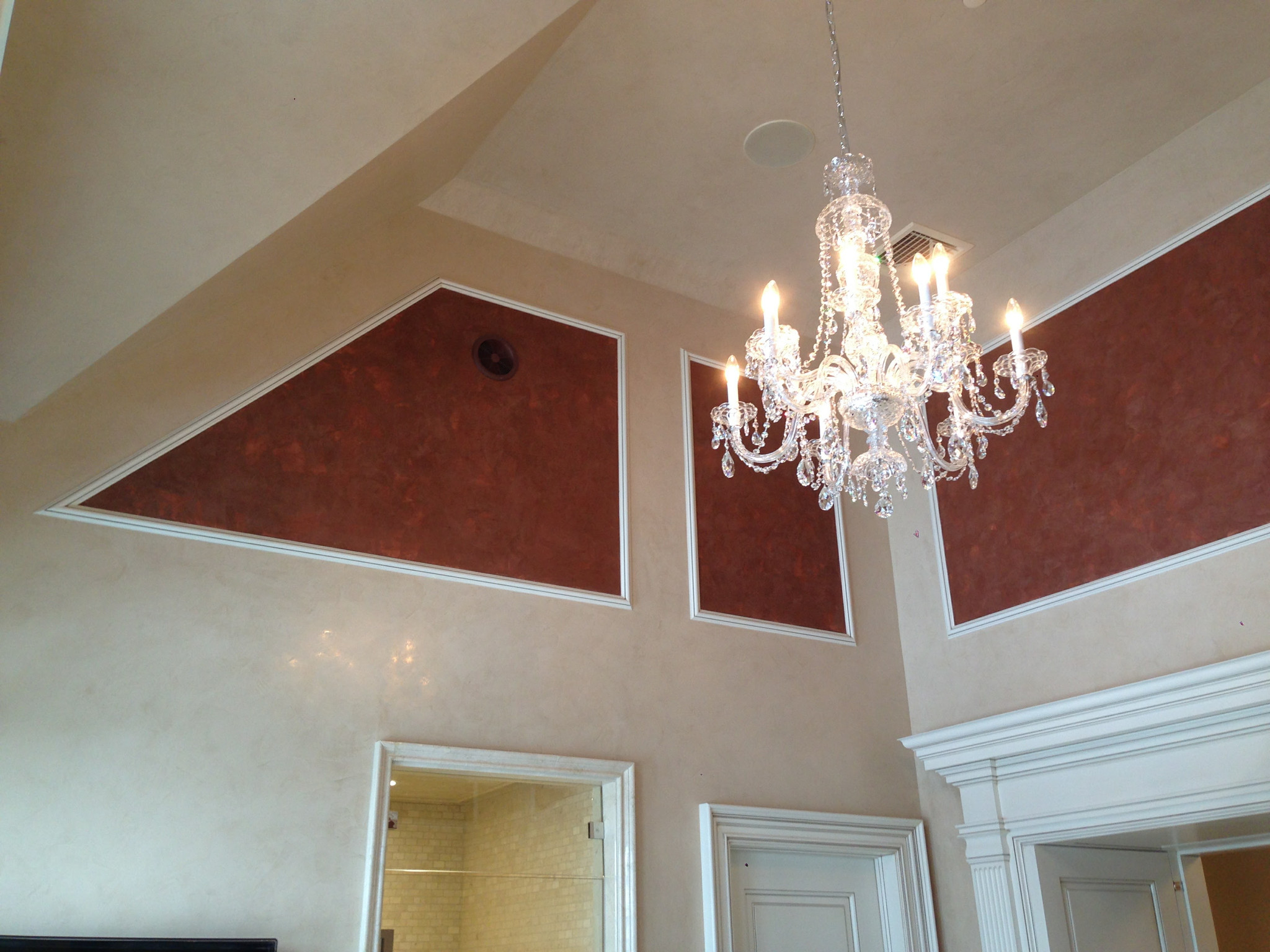 Decorative coffered ceiling with terracotta inset panels and chandelier