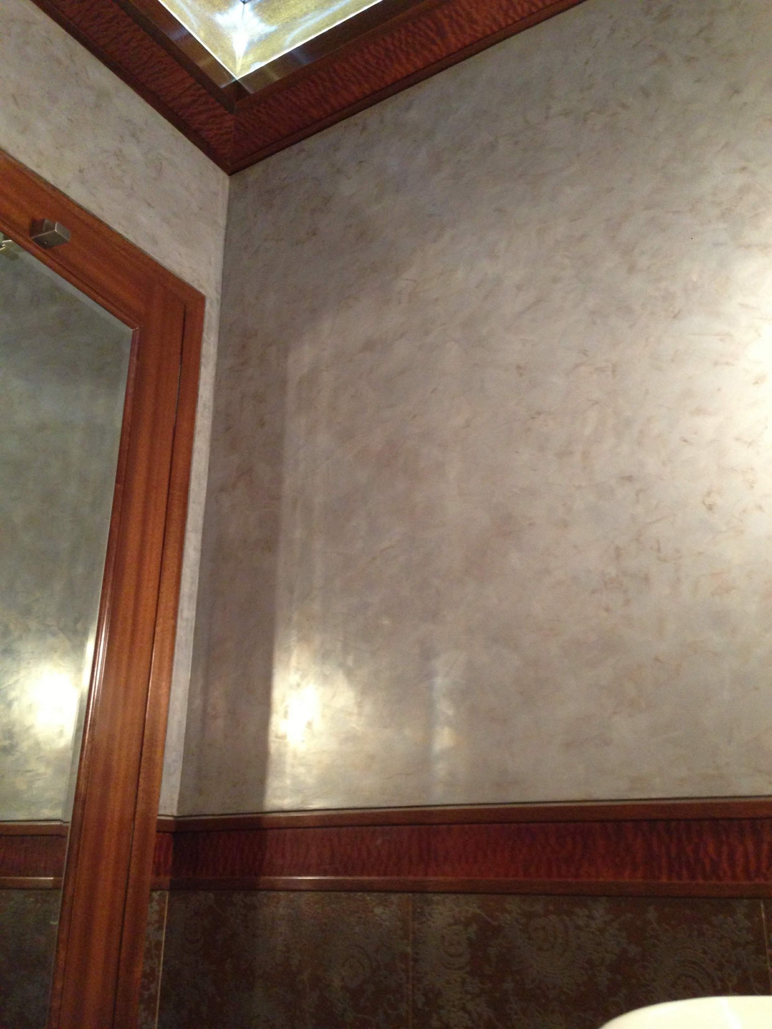 Venetian plaster walls and wood trim in an interior space.