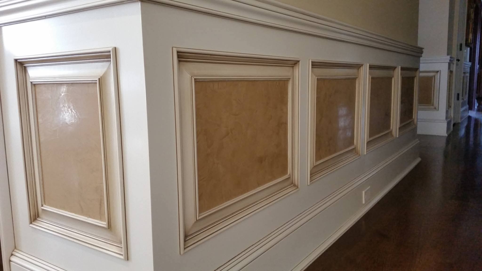 Wainscoting and wall panels with white finish and antiquing glaze