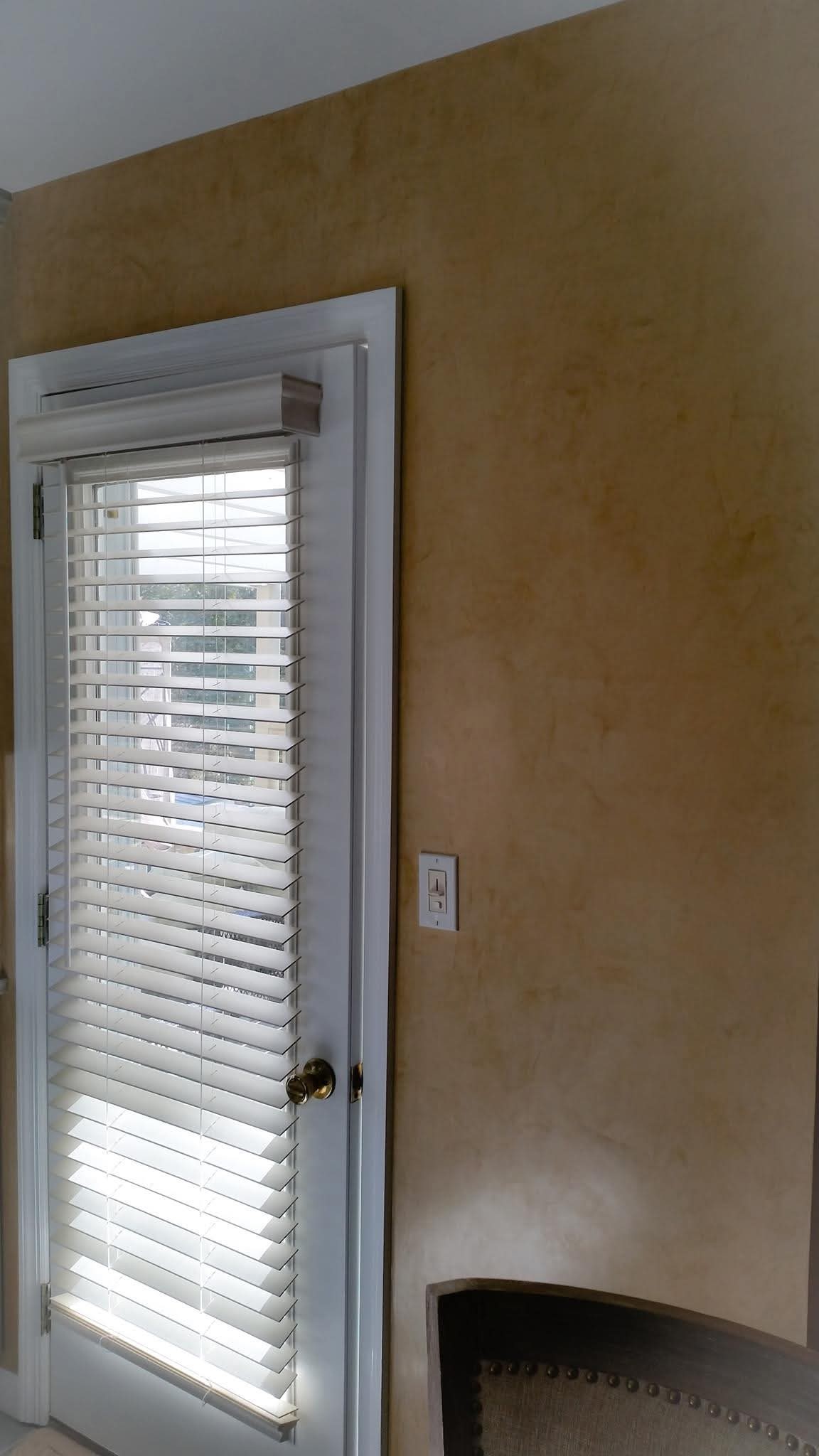 White painted door trim against a glazed wall finish